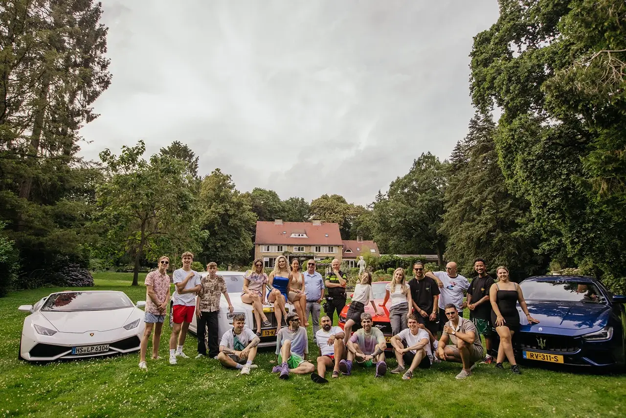 Vessbroz in a beautiful location with other creators, with expensive cars and a large house in the background